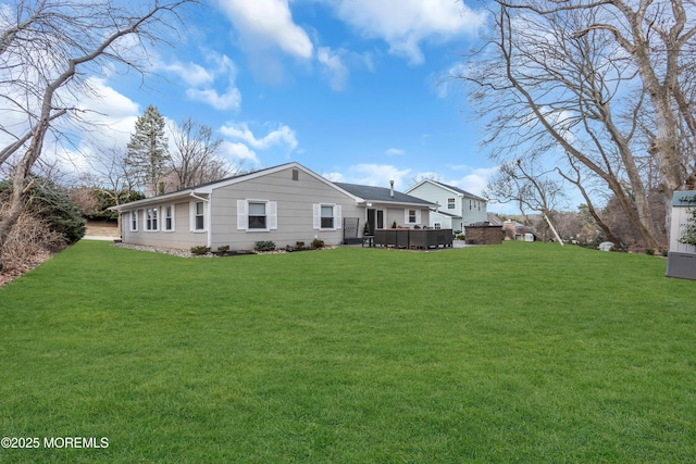 rear view of house featuring a lawn