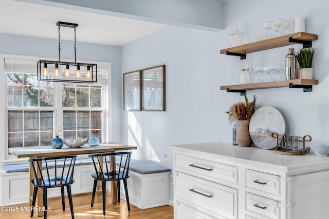 dining space featuring breakfast area and light wood-style flooring