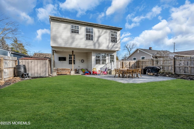 back of house featuring a patio area, a lawn, and a fenced backyard