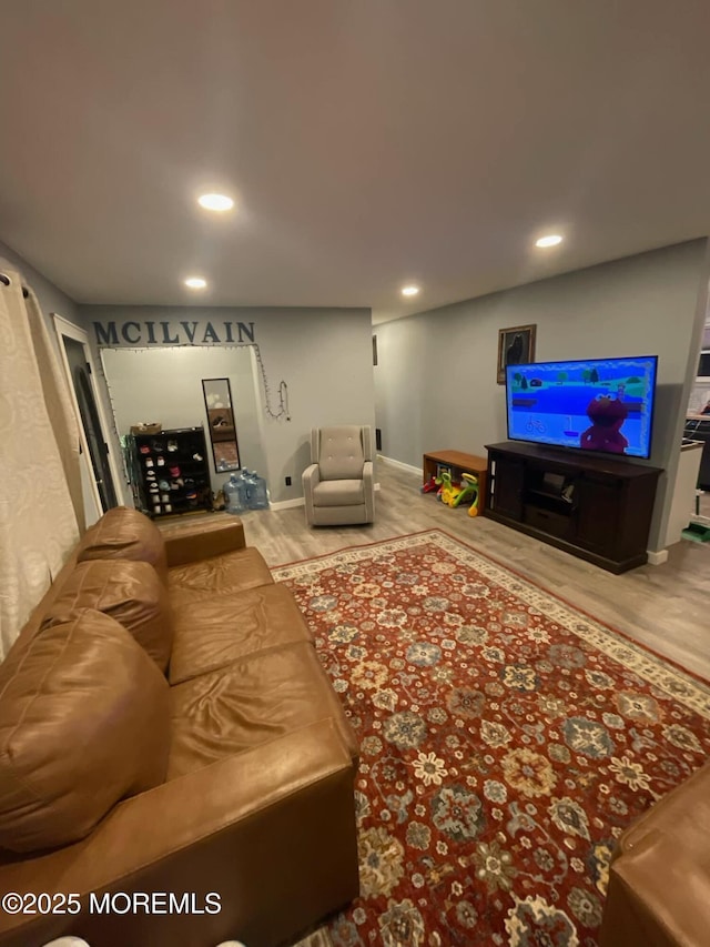 living area with recessed lighting, baseboards, and wood finished floors