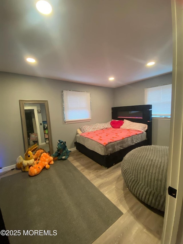 bedroom featuring recessed lighting, baseboards, and wood finished floors