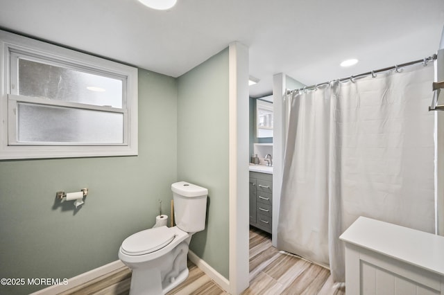 full bathroom featuring baseboards, vanity, toilet, and wood finished floors