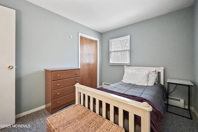 bedroom featuring a baseboard heating unit, carpet flooring, and baseboards