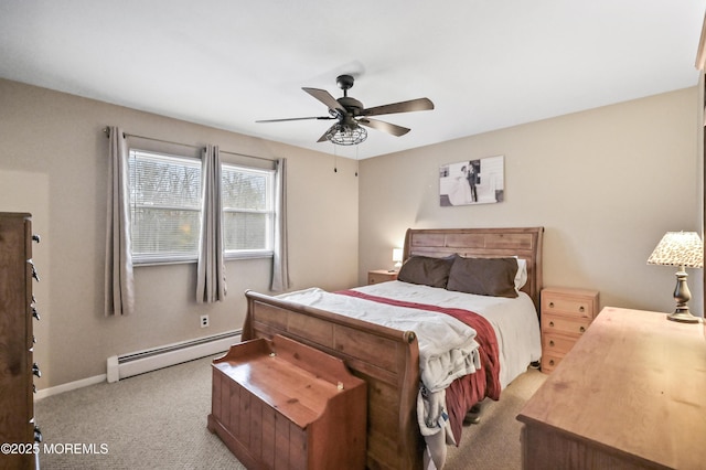 carpeted bedroom with a baseboard heating unit, ceiling fan, and baseboards