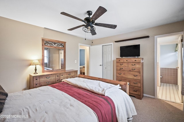 bedroom featuring a closet, carpet flooring, ceiling fan, and ensuite bath