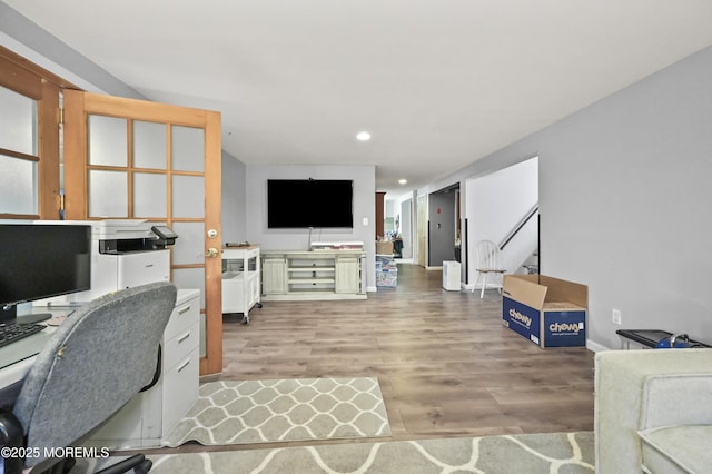 office area with light wood-style flooring, baseboards, and recessed lighting