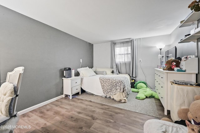 bedroom featuring light wood-type flooring and baseboards