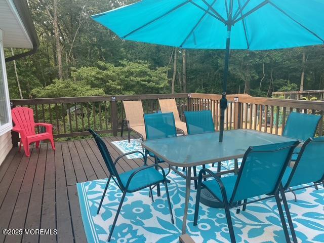 wooden terrace with outdoor dining area