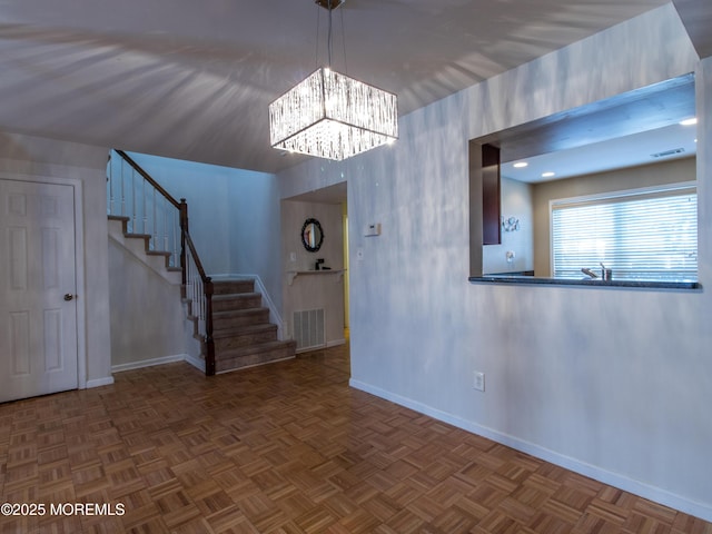 interior space featuring visible vents, baseboards, and stairs