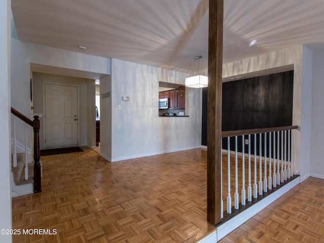 corridor featuring stairs and baseboards