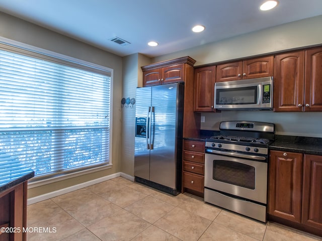 kitchen with light tile patterned floors, baseboards, visible vents, stainless steel appliances, and recessed lighting