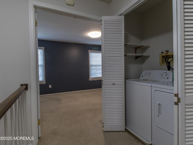 laundry area featuring light carpet, laundry area, and washer and clothes dryer