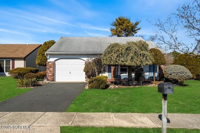 view of front of property featuring a garage, a front lawn, aphalt driveway, and brick siding