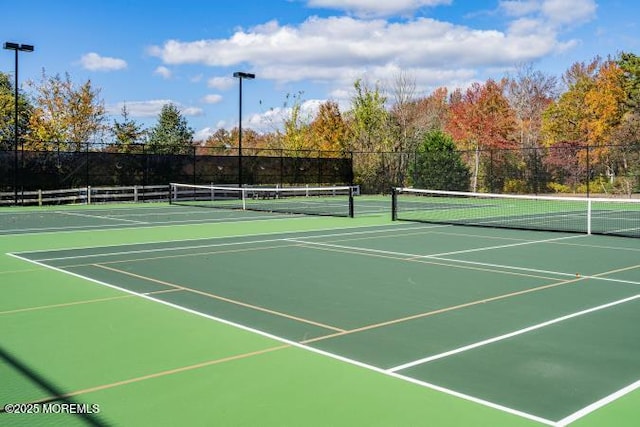 view of tennis court with fence