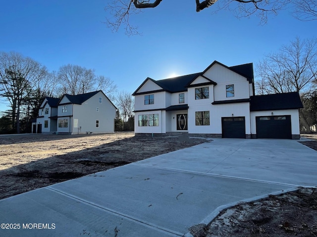 modern farmhouse with a garage and driveway