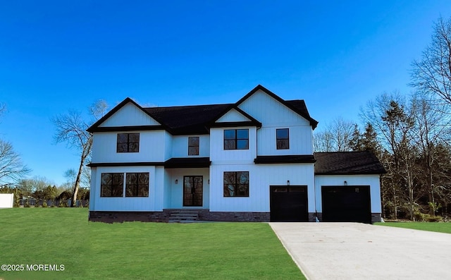 modern inspired farmhouse with concrete driveway, an attached garage, and a front lawn