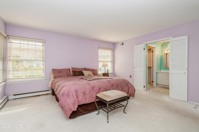 carpeted bedroom with visible vents and a baseboard heating unit