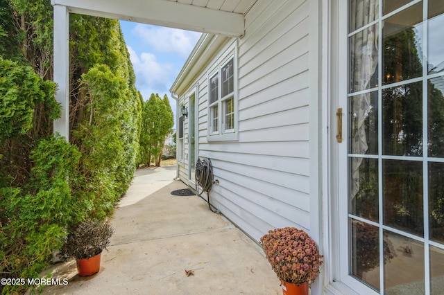 view of property exterior with a patio area