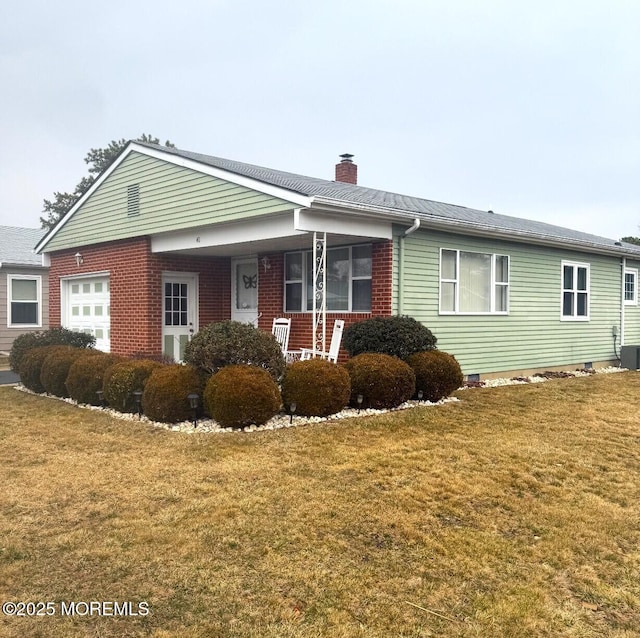 ranch-style home with a garage, a front yard, brick siding, and a chimney