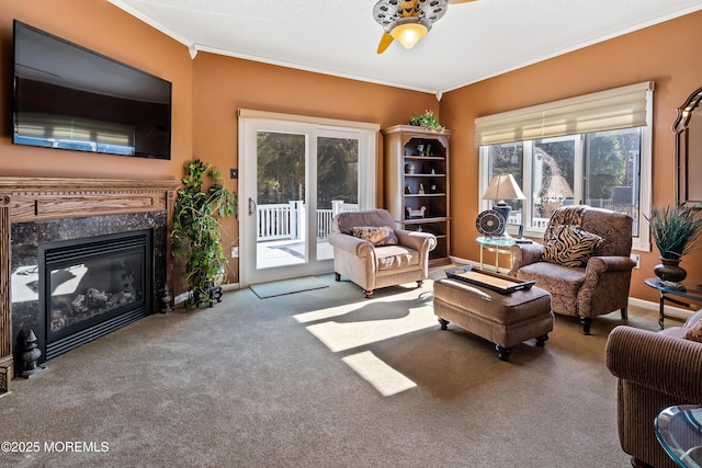 interior space with ceiling fan, a high end fireplace, baseboards, carpet, and crown molding