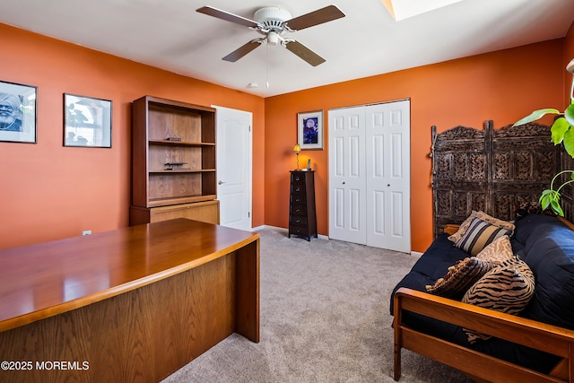 office area with carpet, baseboards, and ceiling fan