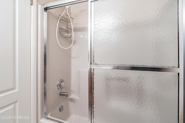 full bathroom featuring shower / bath combination with glass door