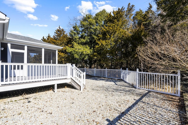 view of yard with a sunroom and fence