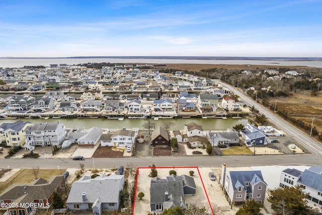 bird's eye view featuring a water view and a residential view