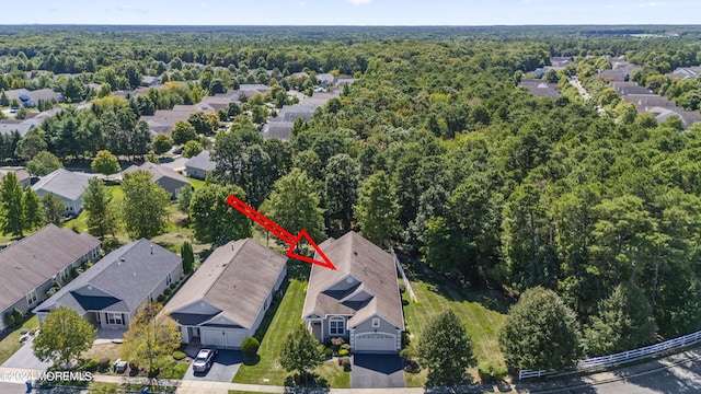 birds eye view of property with a residential view and a wooded view