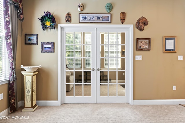 doorway featuring carpet floors, baseboards, and french doors