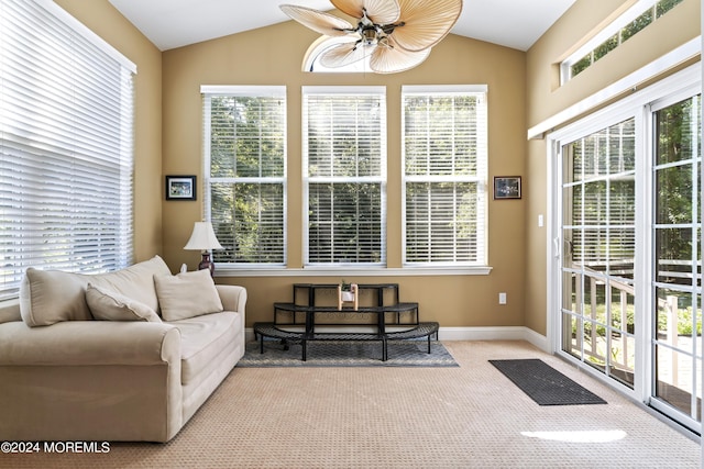 sunroom / solarium with lofted ceiling and a ceiling fan