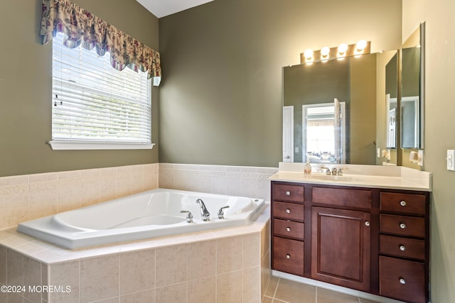 bathroom with a healthy amount of sunlight, a garden tub, vanity, and tile patterned floors