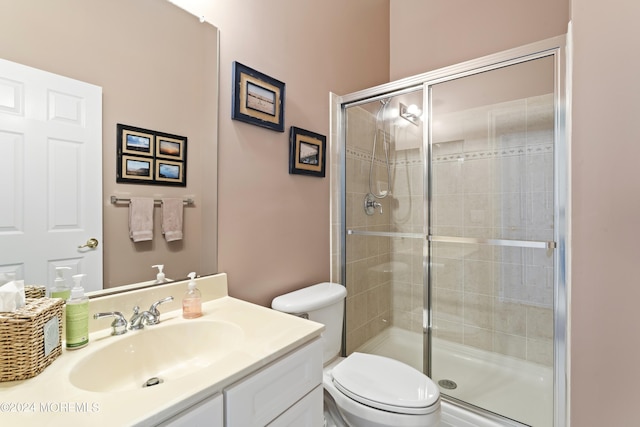 bathroom featuring a stall shower, vanity, and toilet