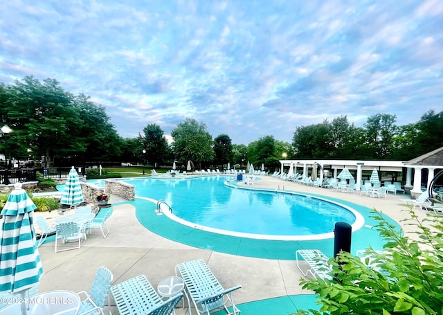 pool featuring a patio area and fence