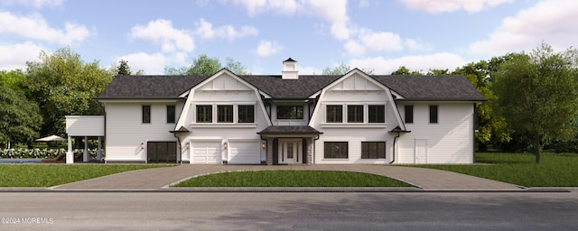 view of front facade featuring driveway, a front lawn, board and batten siding, and an attached garage