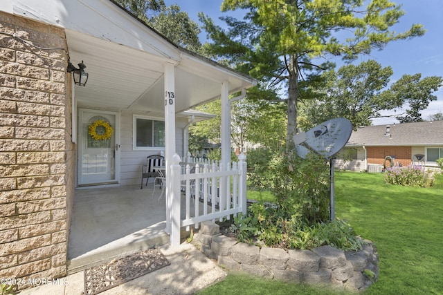 exterior space featuring cooling unit, brick siding, and a yard