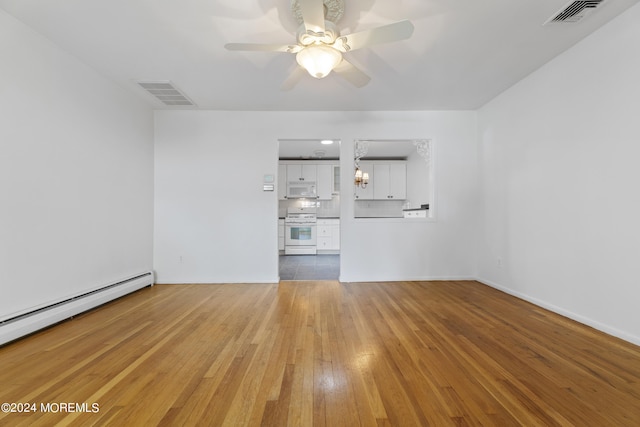 unfurnished living room with baseboard heating, visible vents, ceiling fan, and light wood finished floors