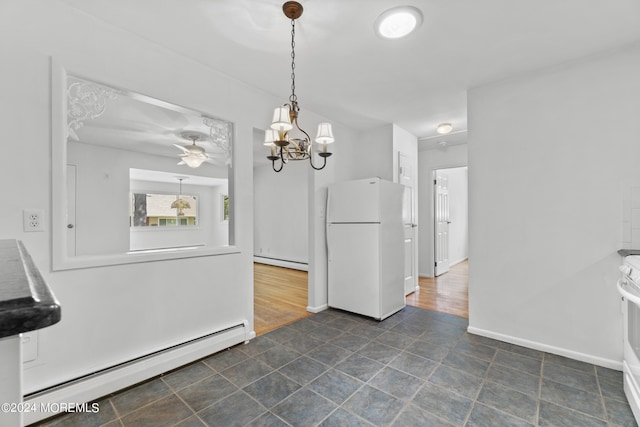 unfurnished dining area with ceiling fan, a baseboard radiator, and baseboards