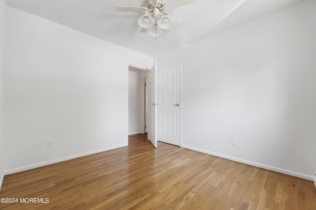 unfurnished room with baseboards and wood finished floors