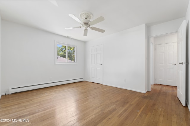 unfurnished bedroom with a ceiling fan, a baseboard radiator, baseboards, and light wood finished floors