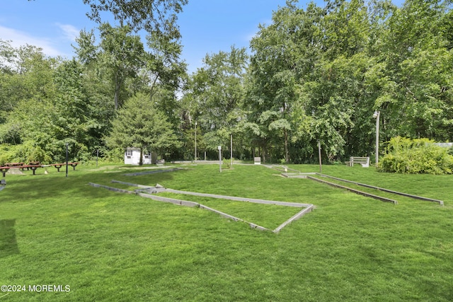 surrounding community with a yard and an outdoor structure