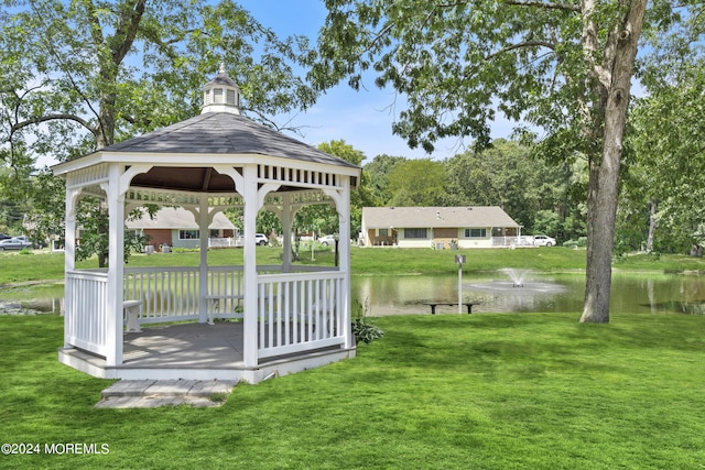 exterior space with a water view, a yard, and a gazebo