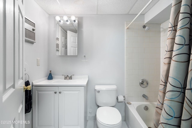 bathroom featuring toilet, a paneled ceiling, vanity, and shower / tub combo with curtain