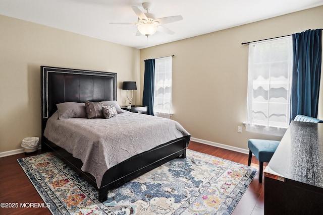 bedroom with a ceiling fan, baseboards, and wood finished floors