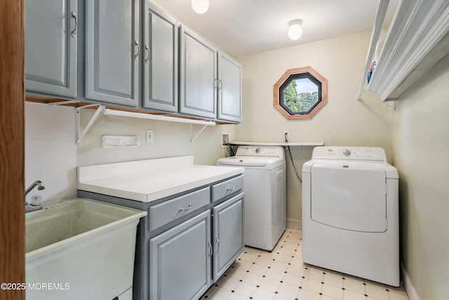 washroom with light floors, cabinet space, independent washer and dryer, and a sink