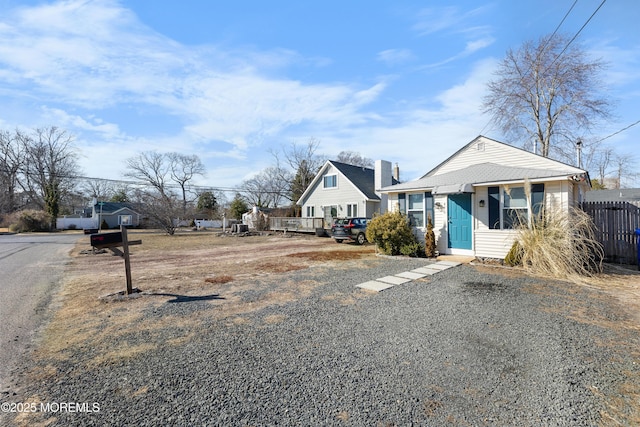 bungalow-style house with fence