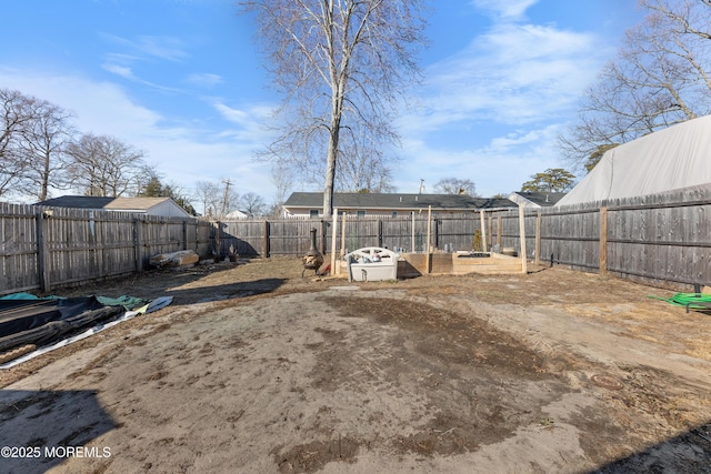 view of yard featuring a vegetable garden and a fenced backyard