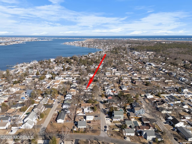 drone / aerial view featuring a residential view and a water view