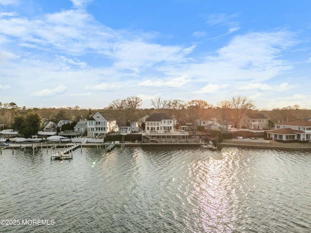 property view of water featuring a residential view and a boat dock