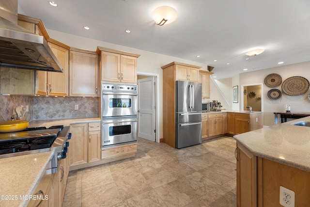 kitchen with stainless steel appliances, light stone counters, extractor fan, and backsplash